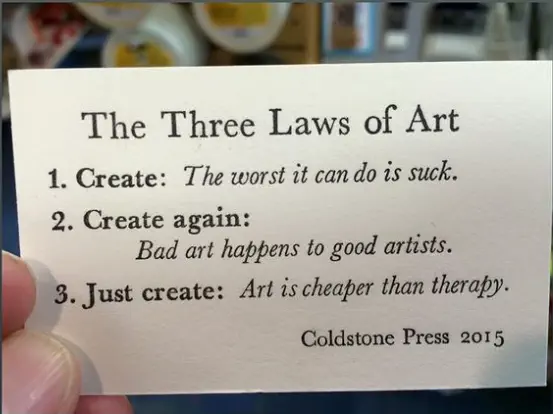 A white card with 3 points describing The Three Laws of Art